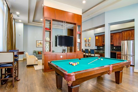 a pool table in a living room with a tv